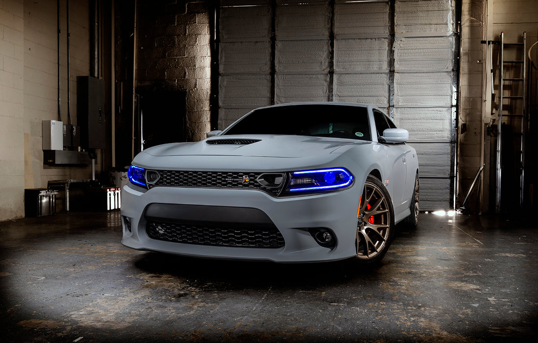 Three quarters view of a grey Dodge Charger with blue headlight DRLs.