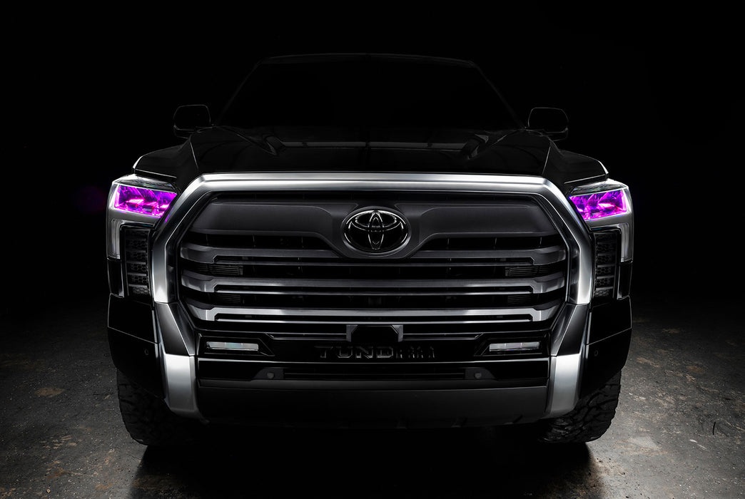  Straight front view of a black Toyota Tundra with pink demon eye projectors.