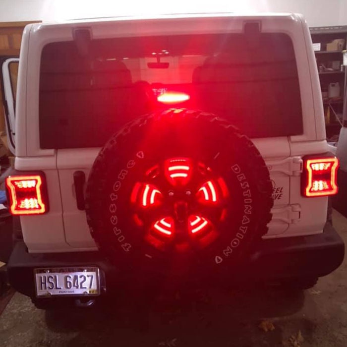Rear view of a Jeep wtih LED Illuminated Spare Tire Wheel Ring Third Brake Light installed.