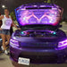 Front end of a purple Dodge Charger with purple headlight DRLs.