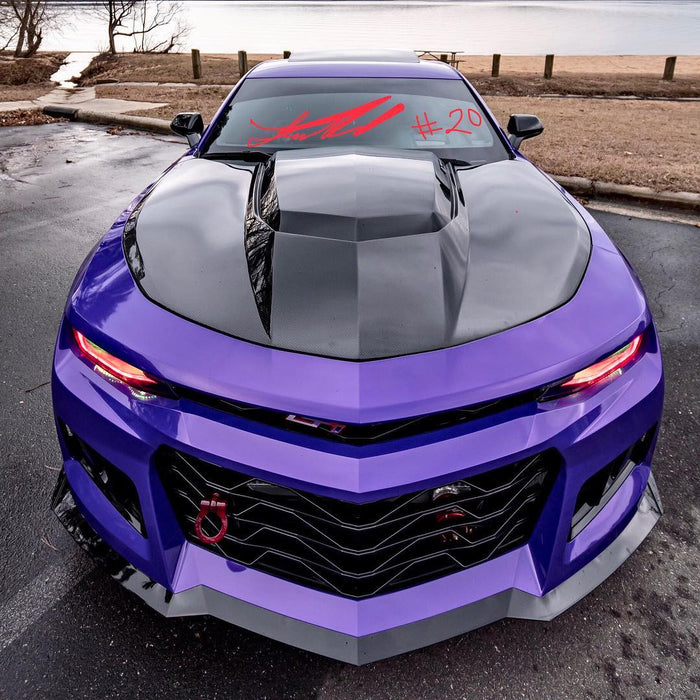 Front end of a Chevrolet Camaro with red LED headlight DRLs.