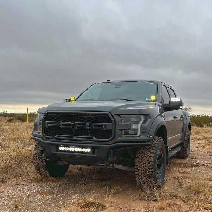 Three quarters view of a Ford Raptor with 2015-2020 Ford F-150 LED Off-Road Side Mirrors installed.