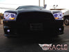 Front end of a black Dodge Charger with white LED headlight halo rings installed.