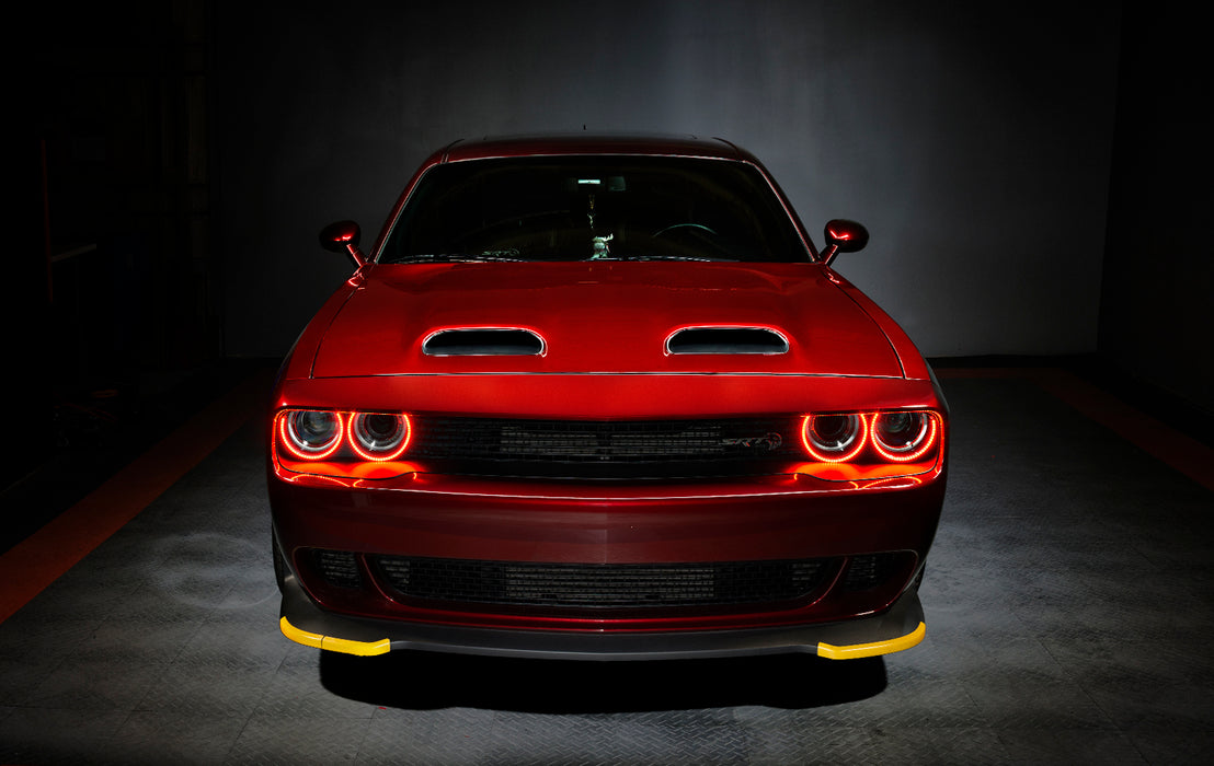 Front end of a red Dodge Challenger with red halo headlights.