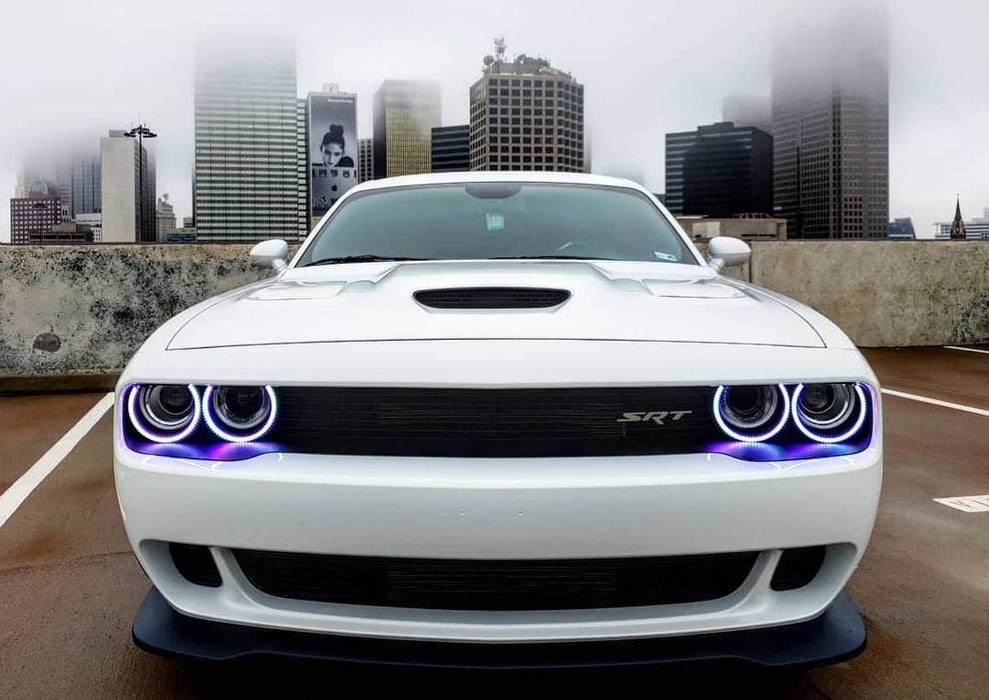Front end of a white Dodge Challenger with white LED headlight halo rings installed.