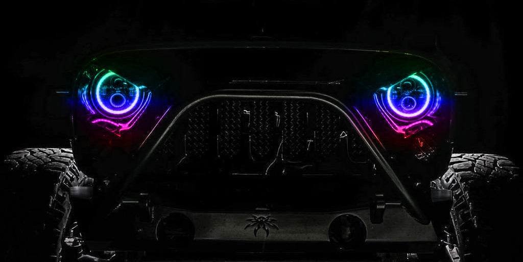 Front end of a Jeep Wrangler with Dynamic ColorSHIFT 7" High Powered LED Headlights installed.