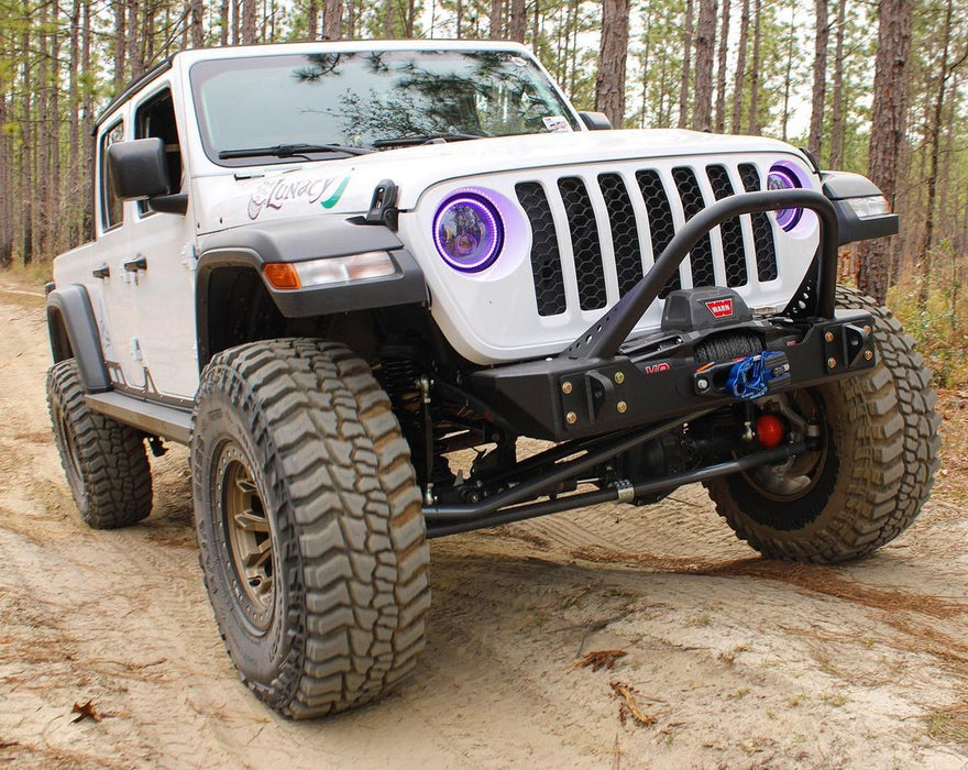 Three quarters view of a Jeep Gladiator with 7" High Powered LED Headlights installed, and purple halo rings on.