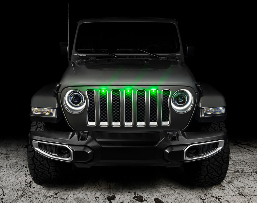 Front end of a Jeep Wrangler JL with green Pre-Runner Style LED Grill Light Kit installed.