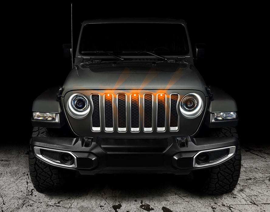 Front end of a Jeep Wrangler JL with amber Pre-Runner Style LED Grill Light Kit installed.