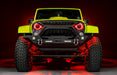 Front view of a yellow Jeep with 7" Oculus Headlights installed, set to red LEDs.