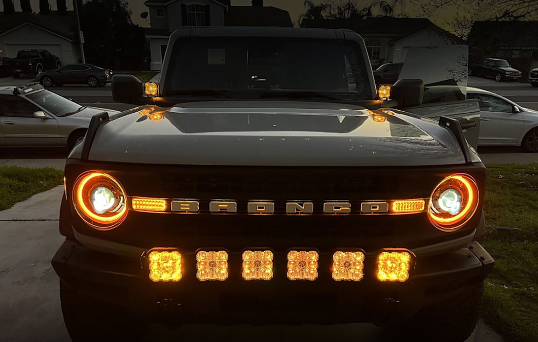Front end of a grey Ford Bronco with multiple LED lighting products installed, including Oculus Headlights.