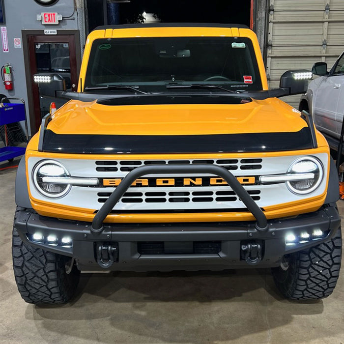 Front view of a yellow Ford Bronco with LED Off-Road Side Mirrors installed and turned on.