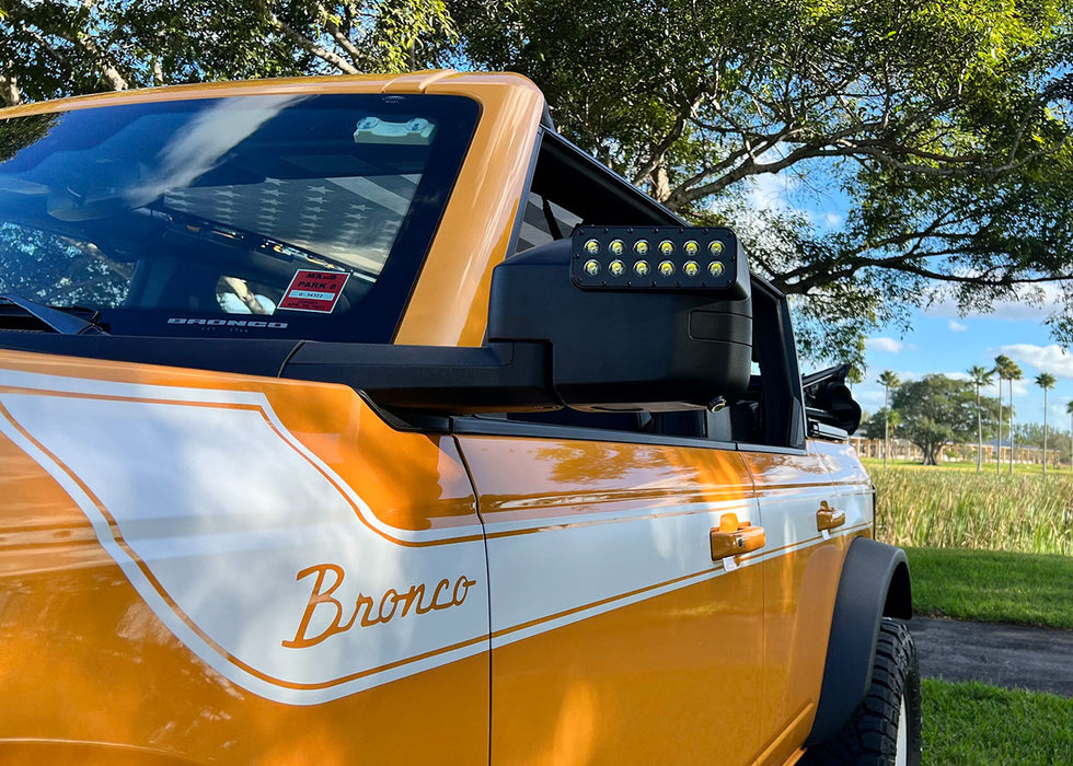 Close-up of LED Off-Road Side Mirrors installed on orange Ford Bronco.