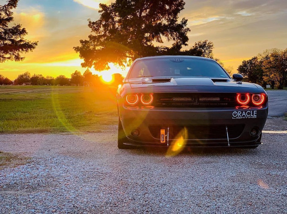 Front view of a Dodge Challenger with red headlight halos.
