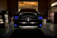 Front end of a RAM truck with Switchback Quad Pre-Assembled Halo Headlights installed and blue halos on.