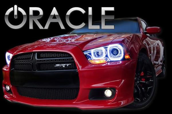 Front end of a red Dodge Charger with white LED headlight halo rings installed.