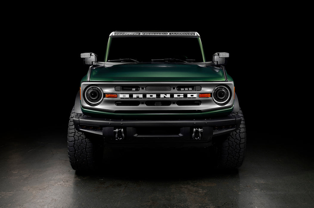 Straight front view of a Ford Bronco with multiple ORACLE Lighting products installed, including Oculus Headlights, LED Off-Road Side Mirrors, and Integrated Roof Light Bar.
