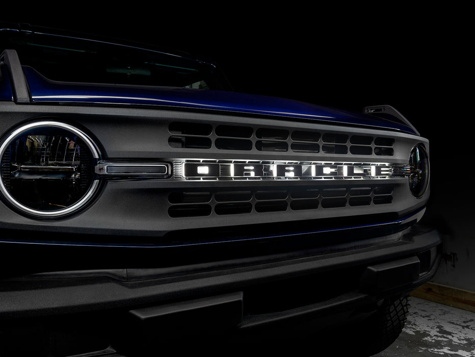 Close-up on the grill of a Ford Bronco with Universal Illuminated LED Letter Badges installed.