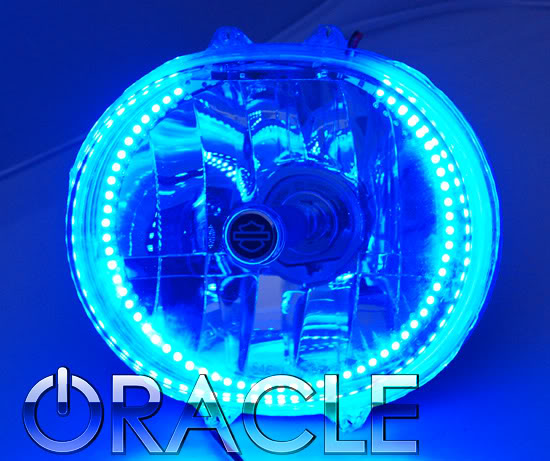 Harley Road Glide headlight with blue LED halo ring installed.