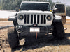 Front end of a white Jeep with Oculus Headlights installed.
