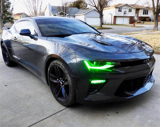 Black camaro in driveway with green DRLs.