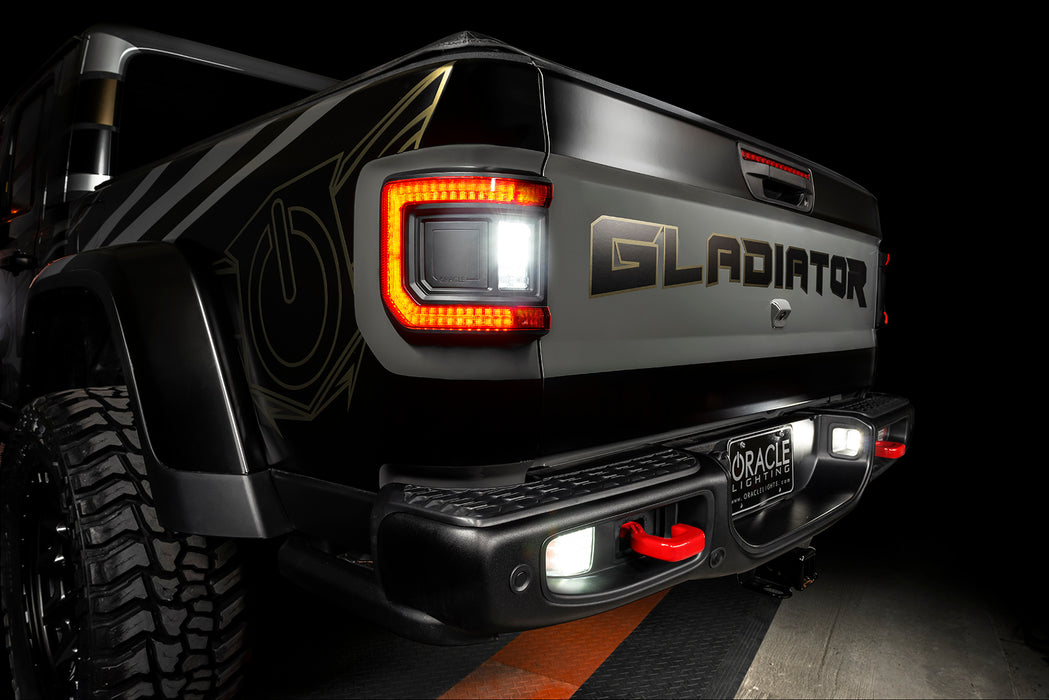 Rear end of a Jeep Gladiator with Flush Mount LED Tail Lights installed and reverse lights on.
