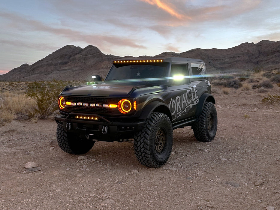 ORACLE Lighting Bronco parked in the desert with LED Off-Road Side Mirrors glowing.