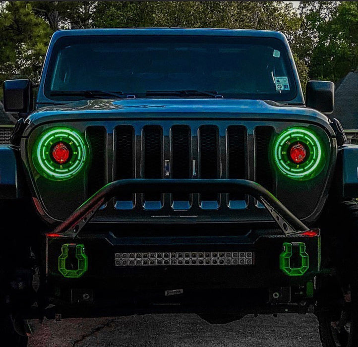 Front end of a Jeep with ColorSHIFT Oculus Headlights installed, and green halo rings.