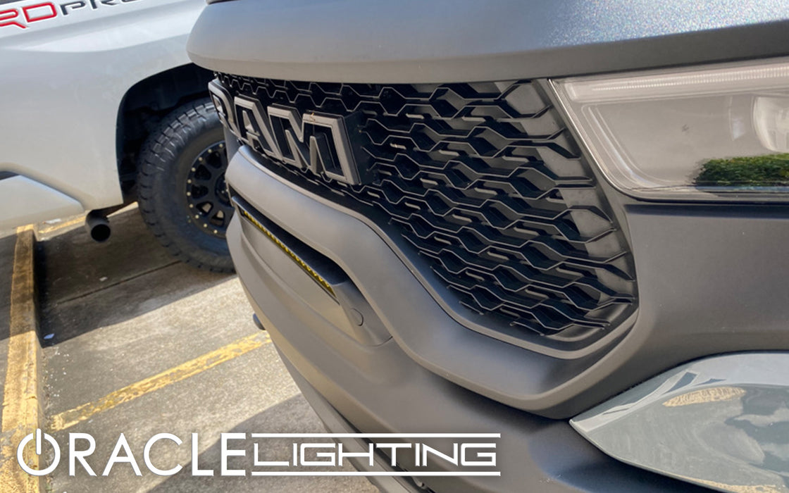 Extreme close-up of of a Front Bumper Flush LED Light Bar System with yellow LEDs installed on a RAM TRX.