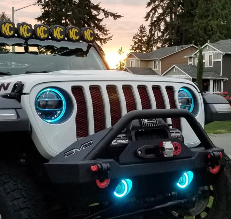 Front end of a white Jeep Wrangler JL equipped with cyan headlight and fog light DRLs.