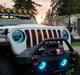 Front end of a white Jeep Wrangler JL equipped with cyan headlight and fog light DRLs.