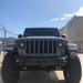 Front end of a Jeep Wrangler with High Performance 20W LED Fog Lights installed.