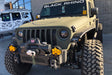 Close-up on the front end of a Jeep Wrangler with Oculus Headlights installed.