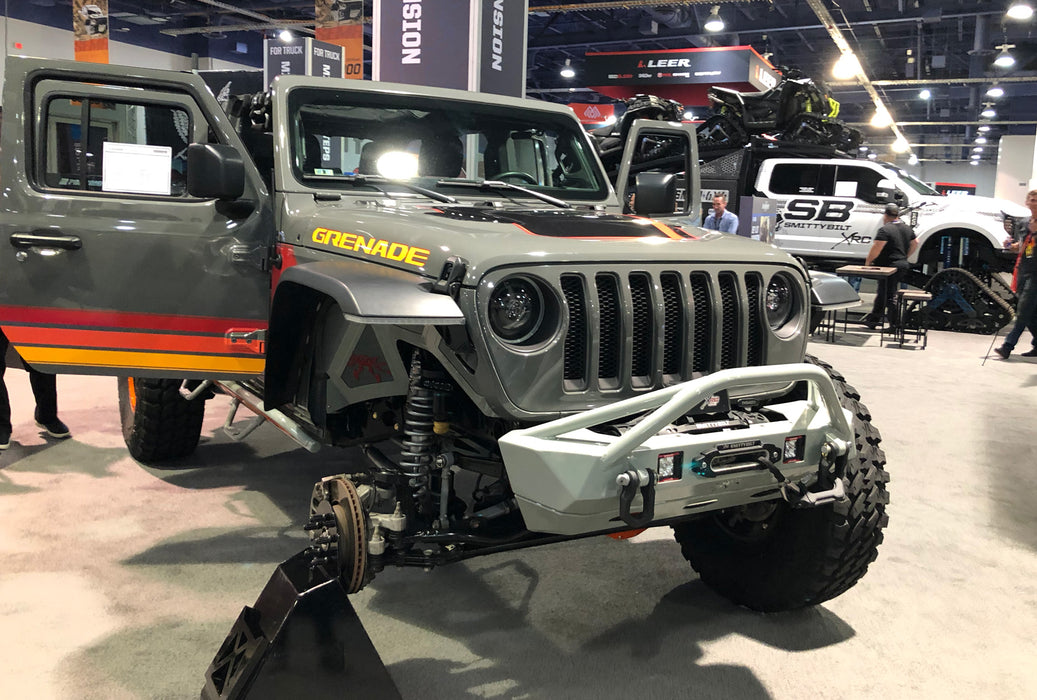 Grey Jeep in a showroom, with Oculus Headlights installed.
