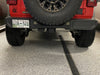 Close-up on the bumper of a Jeep Wrangler JL with Rear Bumper LED Reverse Lights installed.
