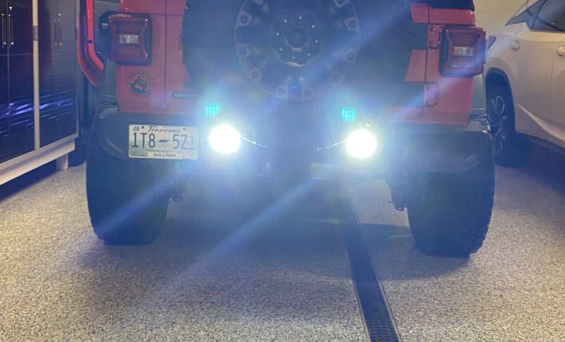Close-up on the bumper of a Jeep Wrangler JL with Rear Bumper LED Reverse Lights installed, and turned on.
