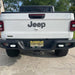 Rear view of a white Jeep Gladiator with Rear Bumper LED Reverse Lights installed.