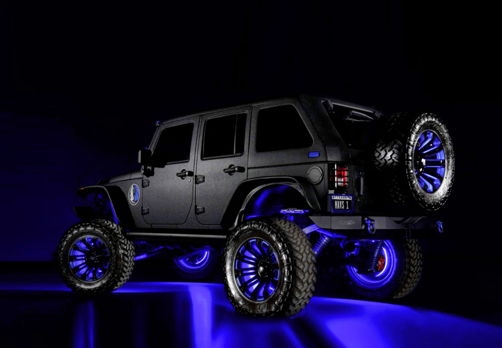 Rear three quarters view of a Jeep with multiple ORACLE Lighting products installed, including LED Illuminated Spare Tire Wheel Ring Third Brake Light.