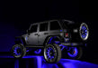 Rear three quarters view of a Jeep with multiple ORACLE Lighting products installed, including LED Illuminated Spare Tire Wheel Ring Third Brake Light.