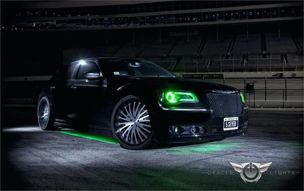 Three quarters view of a Chrysler with green LED headlight halo rings installed.