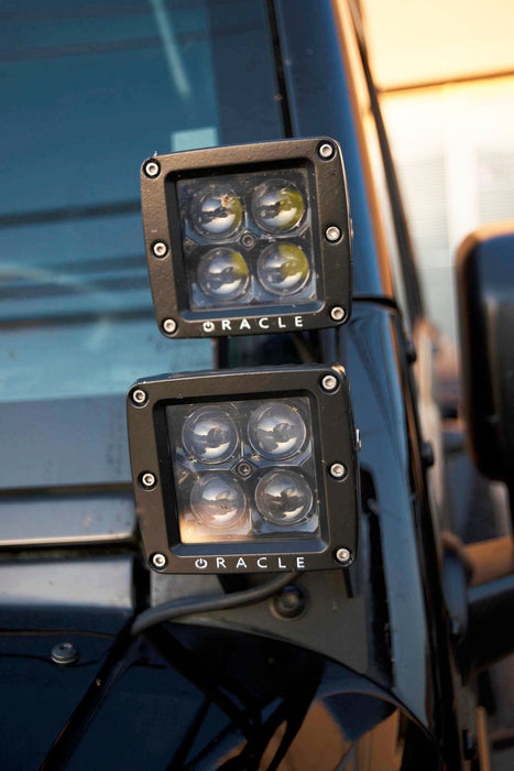 Close-up of Black Series - 7D 3" 20W LED Square Spot/Flood Lights installed on the dashboard of a truck.