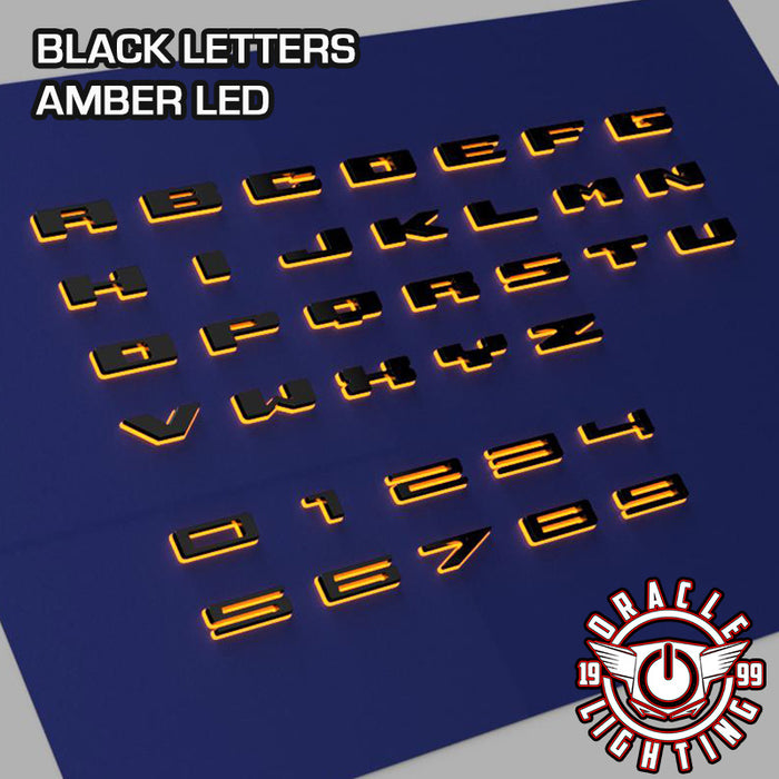 Amber LED Illuminated Letter Badges with Matte Black finish.