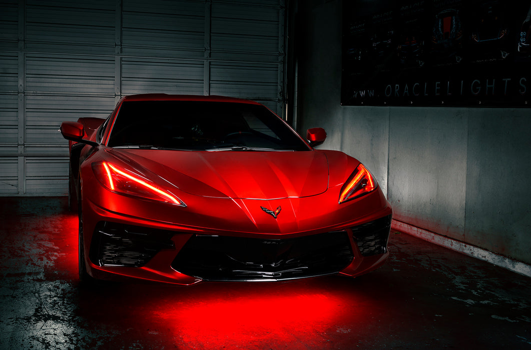 Red Corvette in a garage with red headlight DRLs.