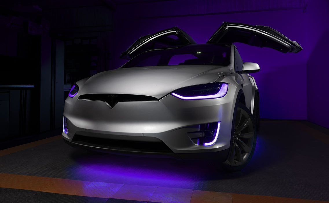 Silver Tesla Model X with purple headlight and fog light DRLs.