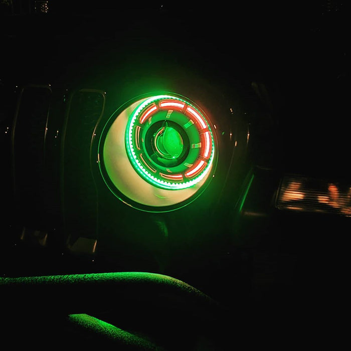 Close-up of a ColorSHIFT Oculus Headlight installed on a Jeep, with multicolored halos on.