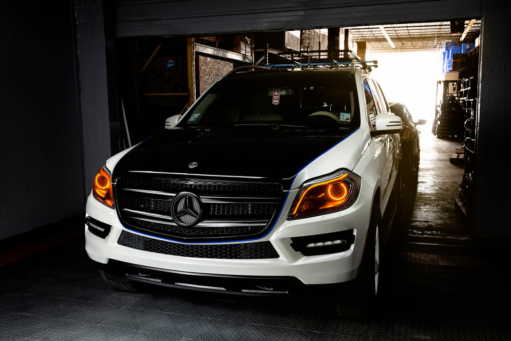 Three quarters view of a Mercedes GL Class with amber headlight halos and DRLs.