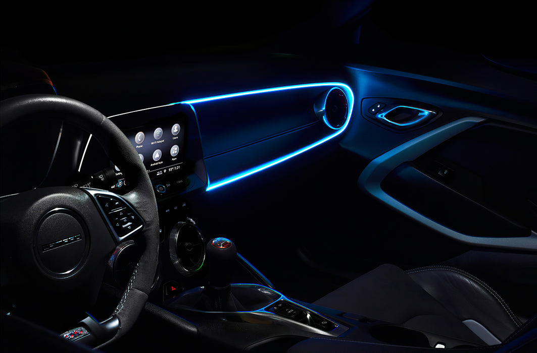 Car interior with white fiber optic lighting installed on the dashboard.