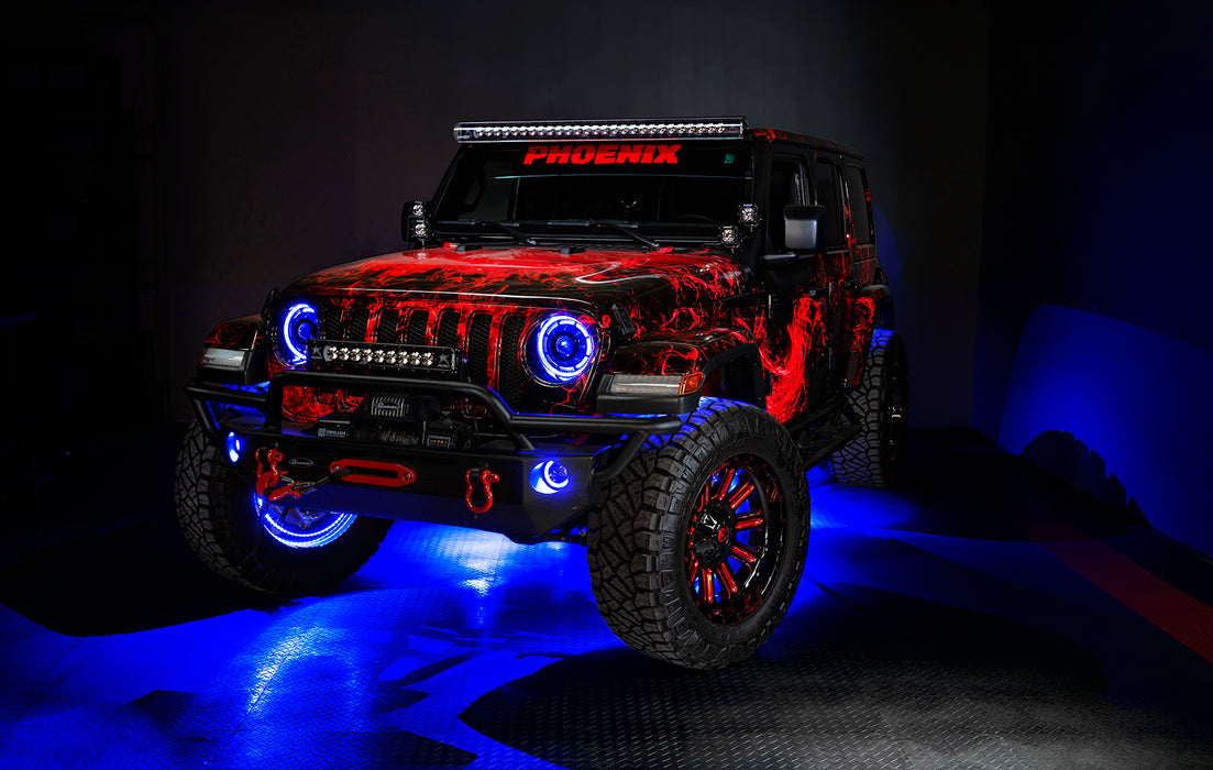 Three quarters view of a red Jeep Wrangler JL, with ColorSHIFT Oculus Headlights, and blue halo rings.