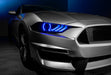 Close-up on a Ford Mustang headlight with blue halos and DRLs.