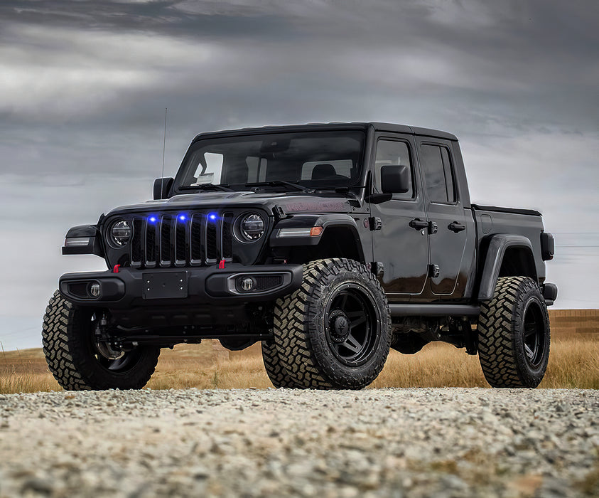 Lifestyle image of a Jeep Gladiator JT with blue Pre-Runner Style LED Grill Light Kit installed.